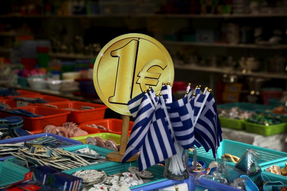 FILE PHOTO:  Greek flags are displayed for sale for one Euro at a shop in Athens
