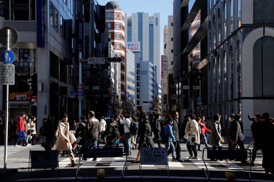 People walk on a street at Tokyo's Ginza shopping district