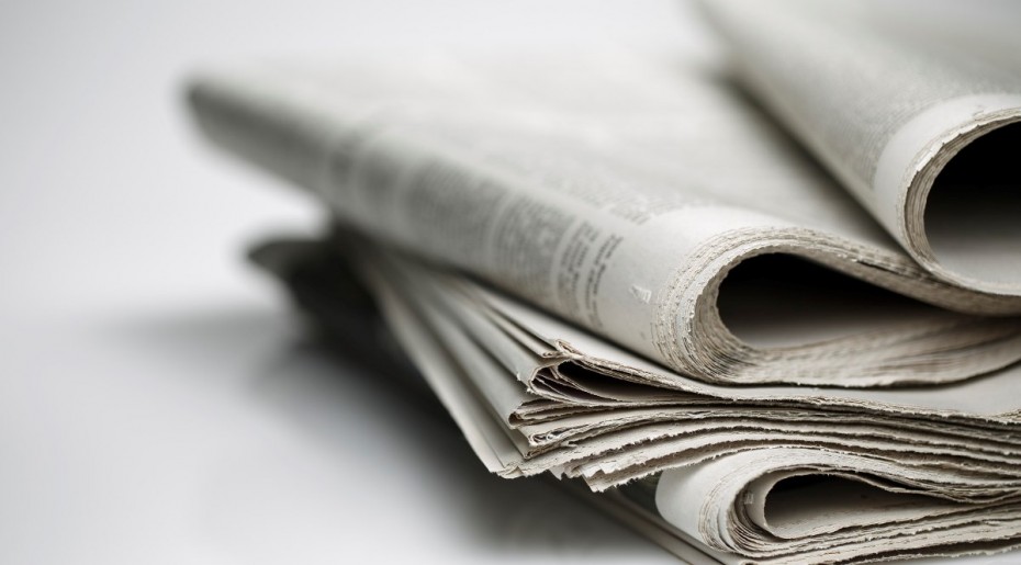 newspapers against plain background shot with very shallow depth of field