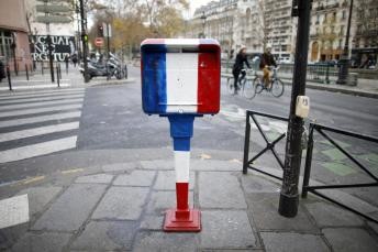 A mailbox is painted in the blue, white, red colors of the French flag, in Paris three weeks after shooting attacks which killed 130 people in the French capital
