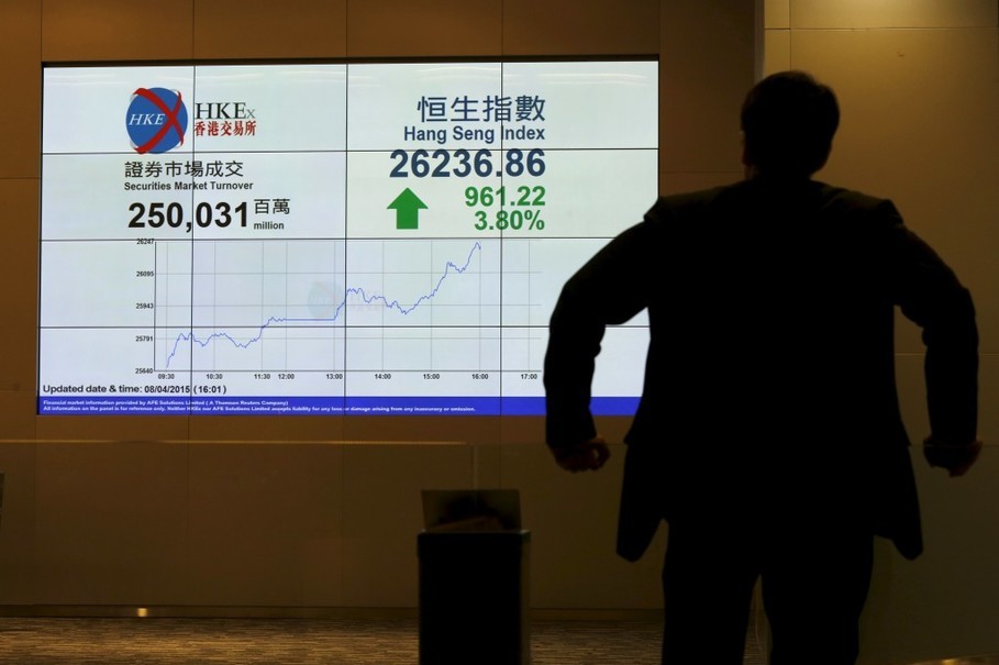 Staff member looks at a panel displaying the closing Hang Seng Index at the Hong Kong Exchanges in Hong Kong