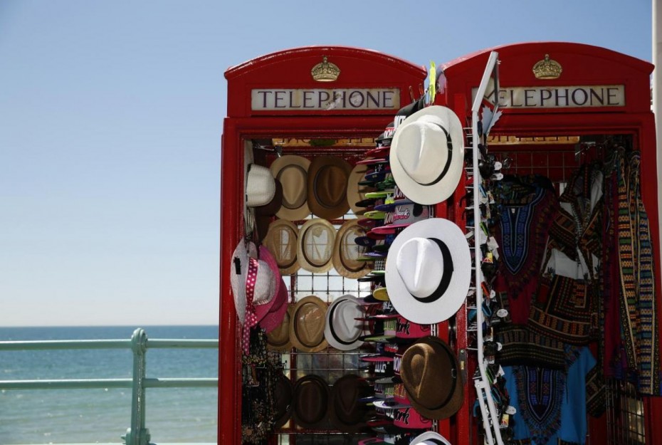 Sun hats are seen for sale in converted telephone boxes on a hot Summer day at Brighton beach
