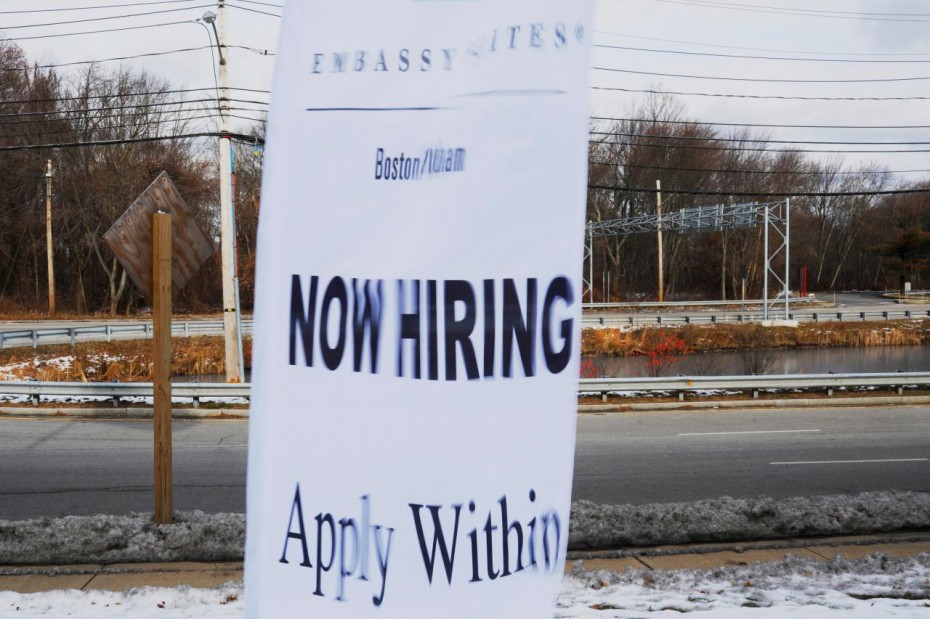 A sign advertises open jobs at an Embassy Suites hotel in Waltham