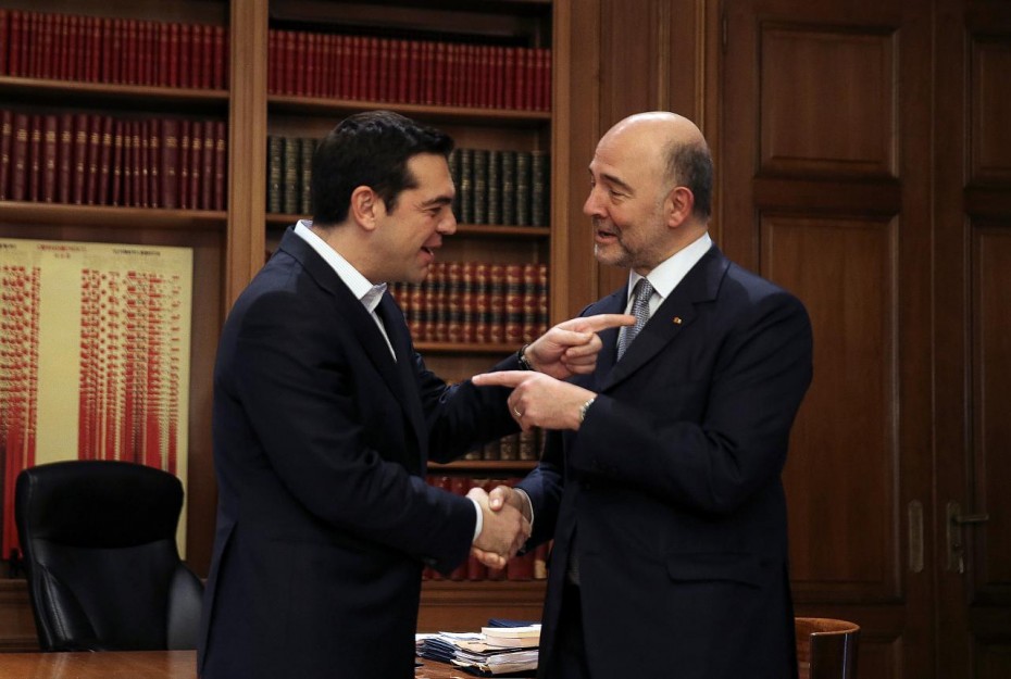 Greek PM Tsipras welcomes European Economic and Financial Affairs Commissioner Moscovici at the Maximos Mansion in Athens