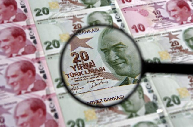 File photo of a 20 Turkish Lira banknote as seen through a magnifying lens in this file photo illustration taken in Istanbul
